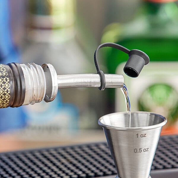 A close-up of a Franmara stainless steel pourer with plastic cork and cap on a bottle.