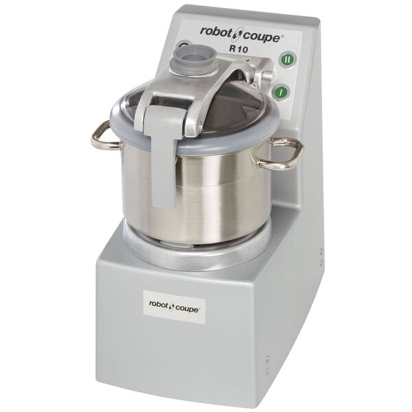 A Robot Coupe stainless steel food processor with a silver lid.