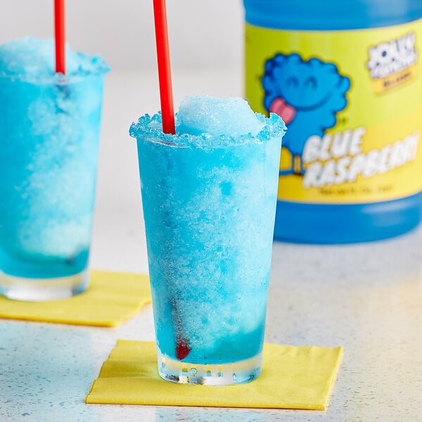 A close up of a blue Jolly Rancher slushy in a glass.