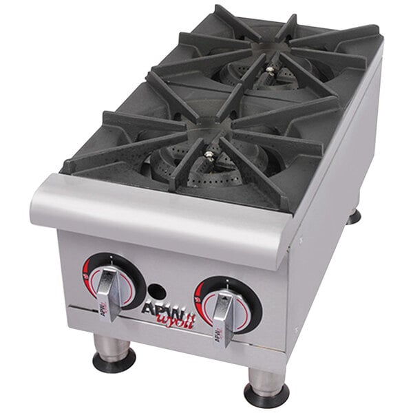 A stainless steel APW Wyott countertop range with four burners.