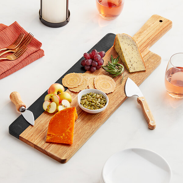 An Acopa acacia wood serving board with food on it and a knife.