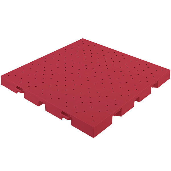 Red plastic EverBlock Flooring drainage top with holes.