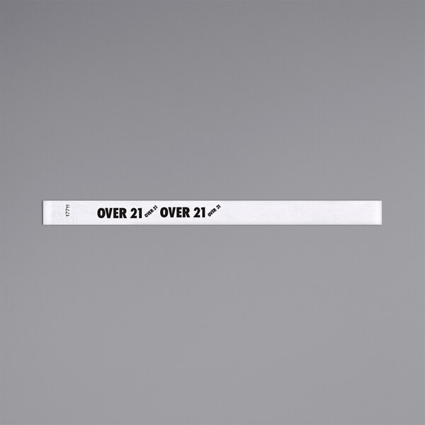 A white rectangular Carnival King wristband with black text reading "OVER 21"