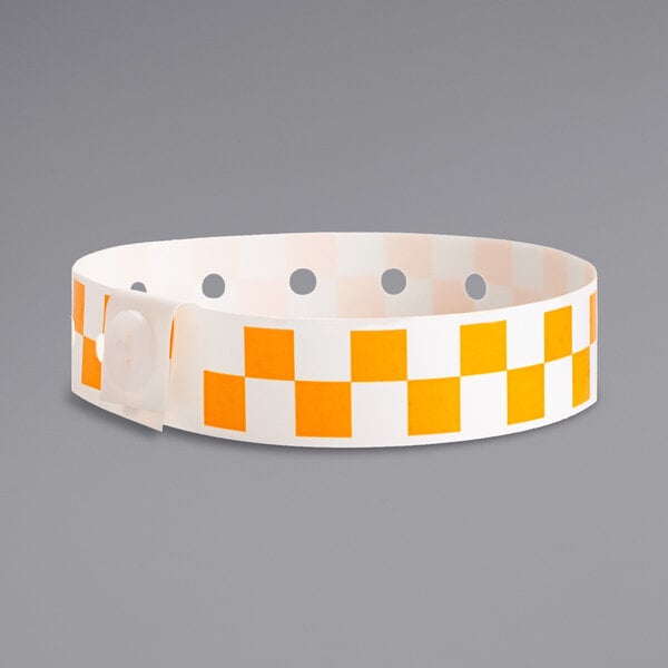 A Carnival King white and orange checkered disposable plastic wristband.