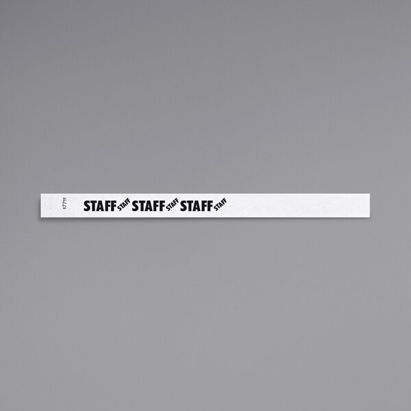 A white rectangular Carnival King wristband with black text reading "STAFF"