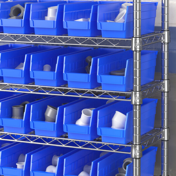 A metal shelf with blue Regency plastic bins on it.