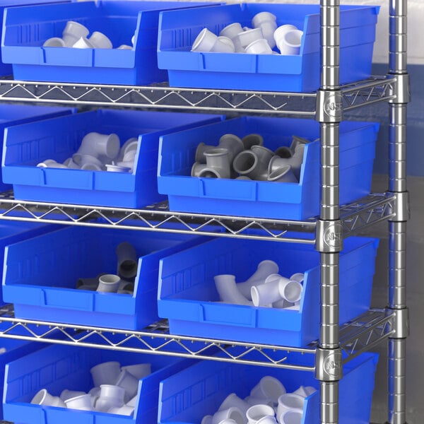 A metal shelving unit with Regency blue plastic bins on the shelves.