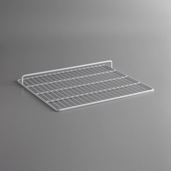 A white wire rack on a gray surface.