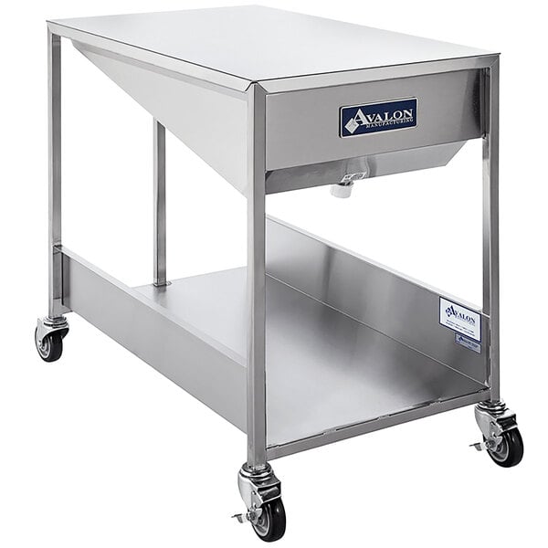 An Avalon Manufacturing stainless steel cart with a stainless steel tray.