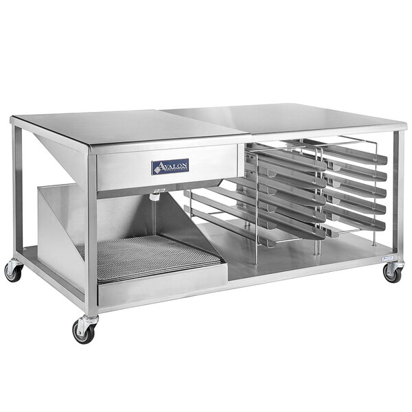 An Avalon Manufacturing stainless steel combination icing/glazing table with a tray on it.