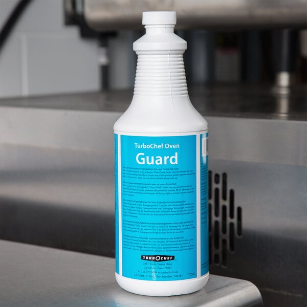A white TurboChef Oven Guard bottle with a blue label on a metal surface.