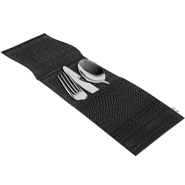 A black woven vinyl silverware pocket with a knife and fork on a black place mat.