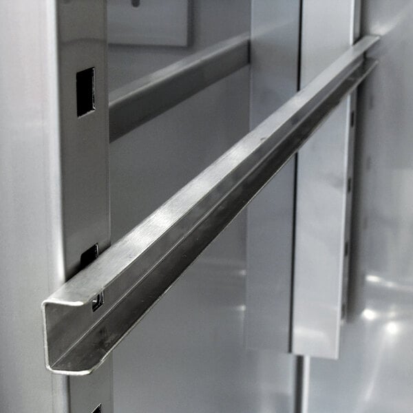 A stainless steel metal shelf rail.