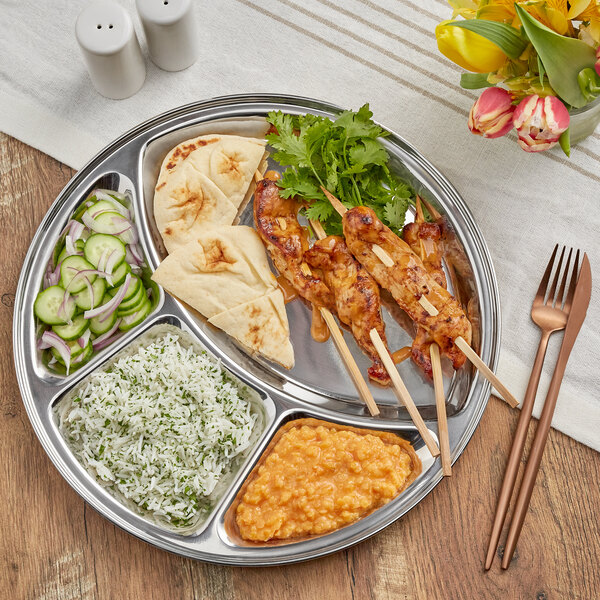 A stainless steel Choice 4 compartment plate with food on it.