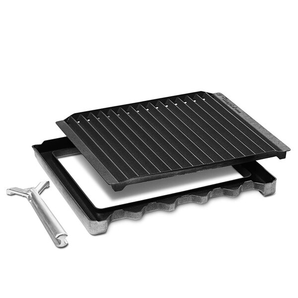 A black Merrychef grill with a metal plate and a white tool.
