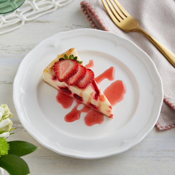 A slice of strawberry cheesecake with strawberries on top on an Acopa Condesa white plate with a fork.