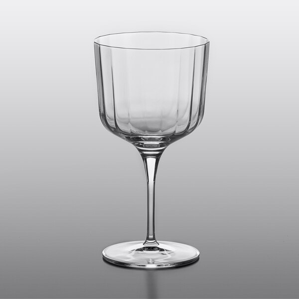 A clear Luigi Bormioli Bach Gin and Tonic glass with a stem.