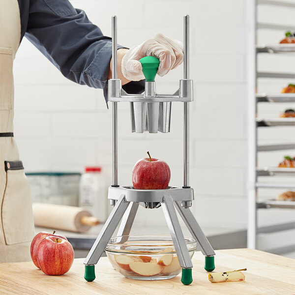 A person using a Garde CORE8 apple corer to cut apples.