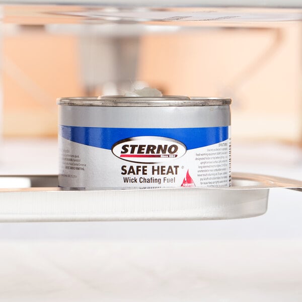 A Sterno 4 Hour Heat-It chafing dish fuel can on a tray.