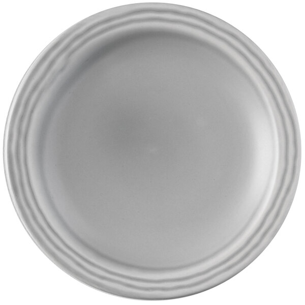 A Dudson Harvest Norse white china plate with a narrow rim decorated with a scalloped design.