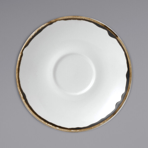 A white Dudson saucer with a brown circle.