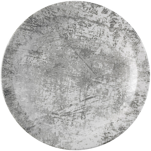 A white plate with a grey speckled surface.