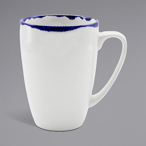A white china mug with a blue rim.