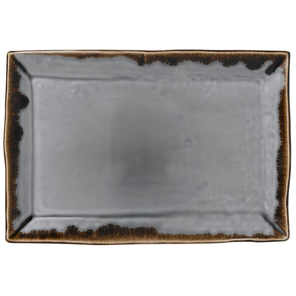 A rectangular white china platter with brown edges.