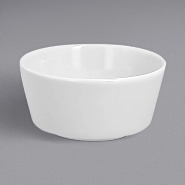A white RAK Porcelain butter ramekin in a white bowl on a gray surface.