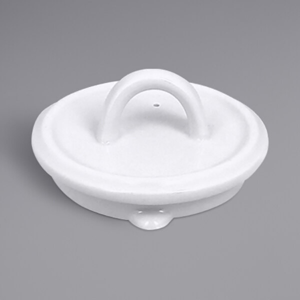 A white RAK Porcelain teapot lid with a handle and a hole.