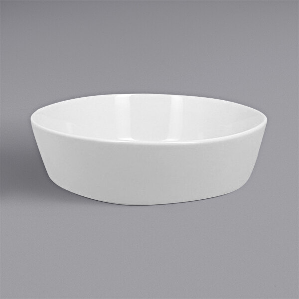A RAK Porcelain Polaris bright white round porcelain bowl on a gray background.