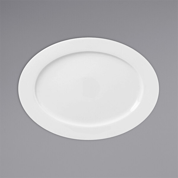 A white RAK Porcelain oval plate with a wide rim on a gray surface.