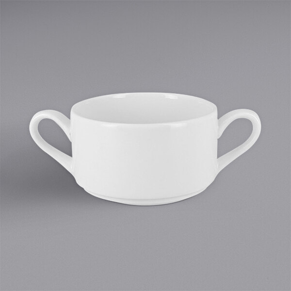 A RAK Porcelain white stackable soup bowl with two handles on a gray surface.