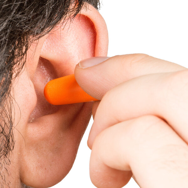A person using a Cordova cordless orange earplug.