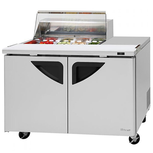 A Turbo Air Super Deluxe refrigerated sandwich prep table with clear lids on two compartments.