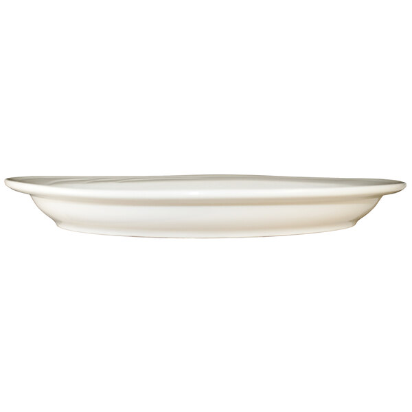 An International Tableware ivory stoneware platter with an embossed design on a white background.