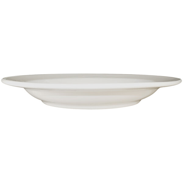 An International Tableware York ivory stoneware pasta bowl with an embossed rim on a white background.