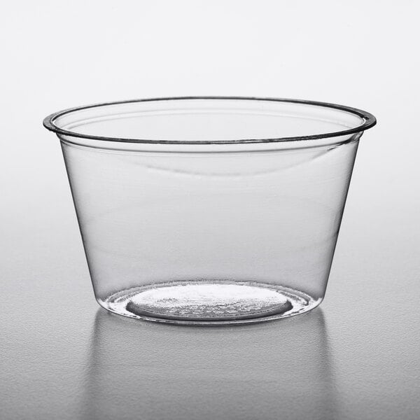 A clear plastic Eco-Products portion cup on a white surface.