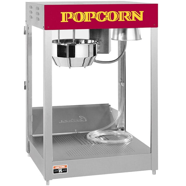 A Cretors popcorn popper with a red bowl on top.