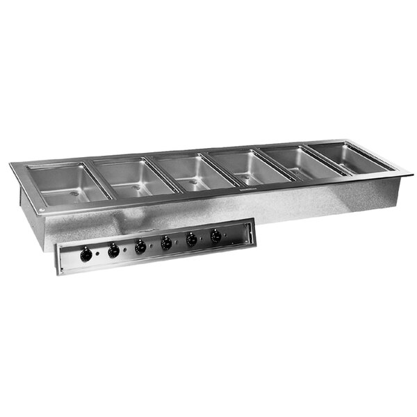 A Delfield stainless steel drop-in hot food well with six compartments on a counter in a professional kitchen.