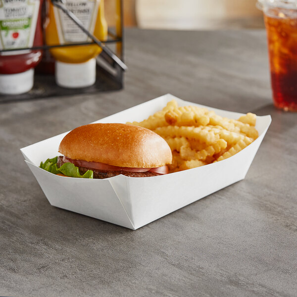 A Dixie white paper food tray holding a hamburger and fries.