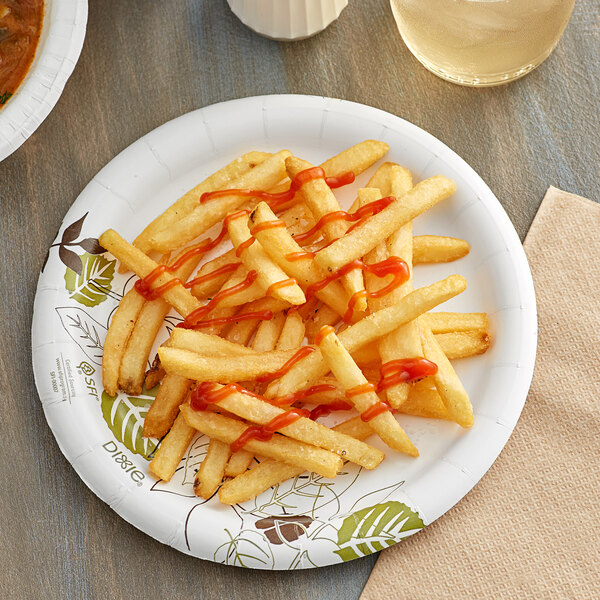 A close up of a Dixie paper plate with french fries and ketchup on it.