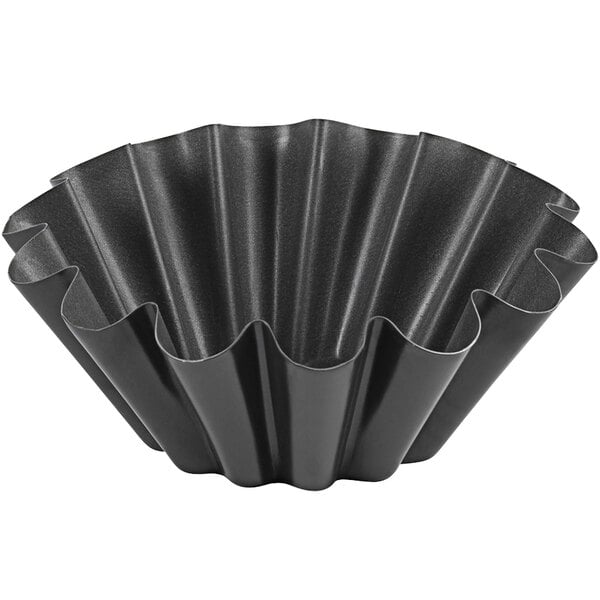 A black metal pan with wavy edges.
