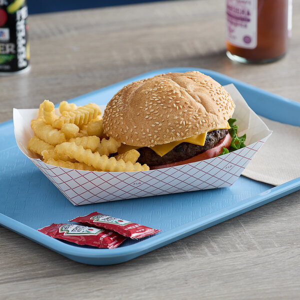 A Dixie red plaid paper food tray with a cheeseburger and fries on it.