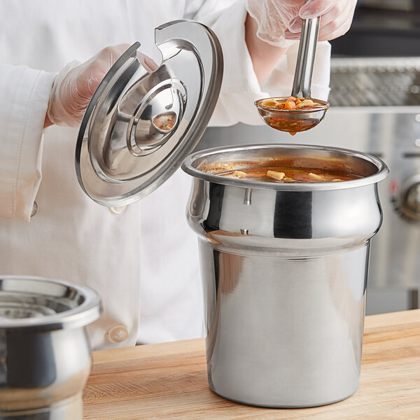 A chef using a Choice stainless steel inset to serve soup.