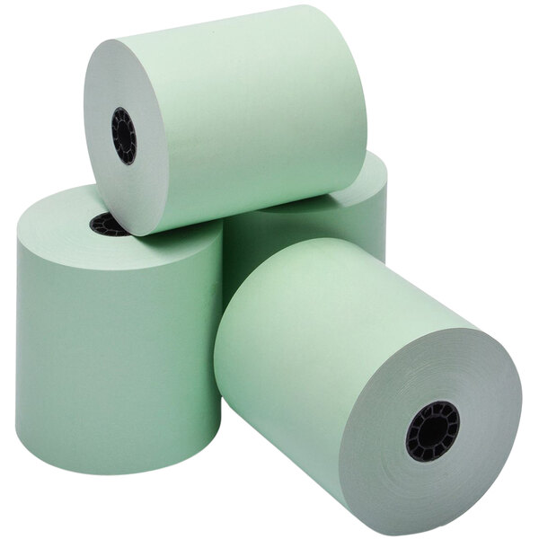 A stack of green Point Plus thermal paper rolls on a table.