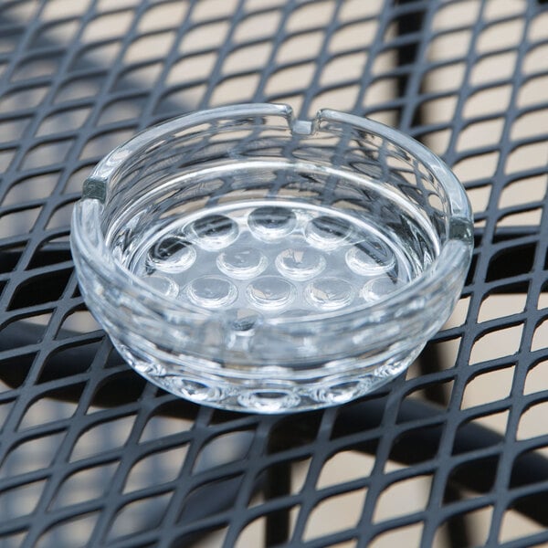 A Libbey Nob Hill glass ashtray on a table.