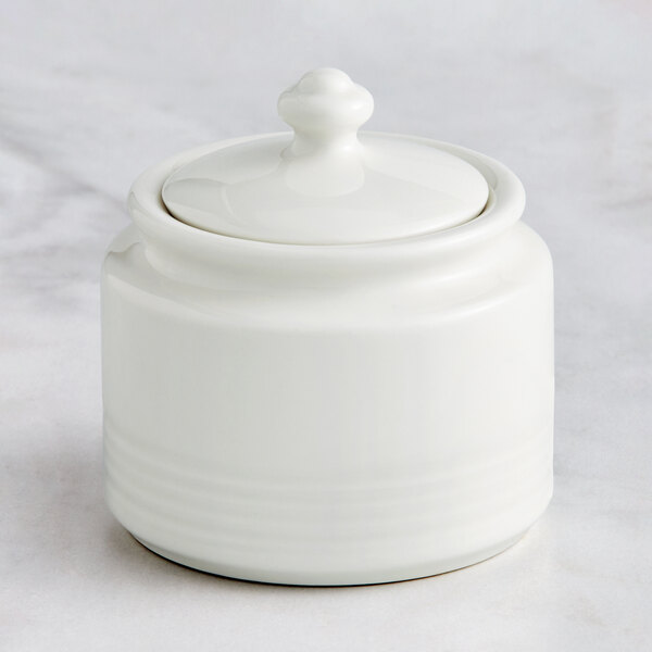 A RAK Porcelain ivory embossed porcelain sugar bowl with a lid.