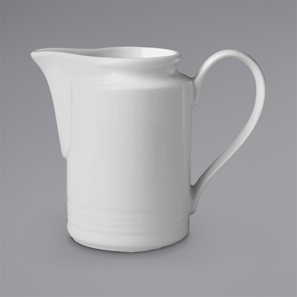 A white RAK Porcelain creamer with a handle.