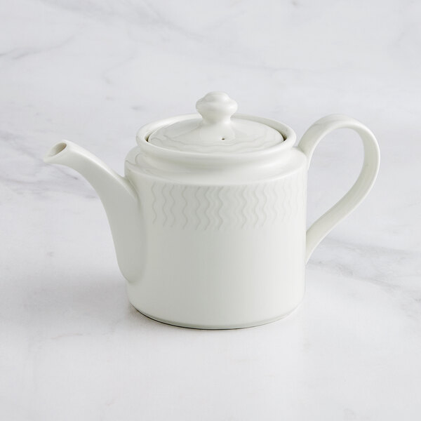 A close-up of a white RAK Porcelain Leon teapot and lid on a marble surface.